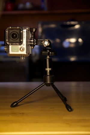 GoPro with 3-way pivot arm atop a baby tripod.